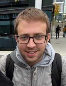 A person wearing glasses and a backpack

Description automatically generated